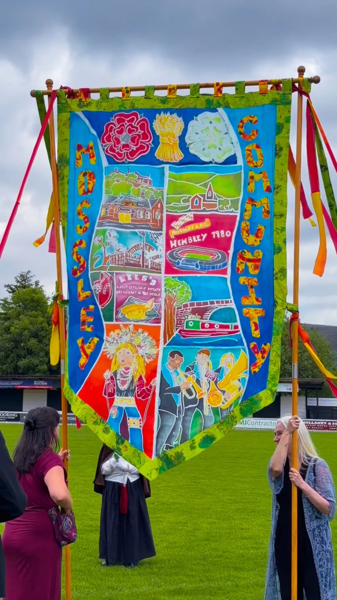 Happy Whit Friday! It was fabulous to unveil this new community banner we made for Mossley Heritage Centre and @mossleytowncouncil at this new wonderful Whit Friday celebration event at Seel Park in Mossley today! It was great to bring their vision to life.

So many hands went into the making of this, and into the future it will be added to by many more hands. 

Design by Lizzie Rigby and Kate Rothery.
Martha Webster worked with lots and lots of children from Micklehurst School as well as Crafty Saturdays here at The Vale to make fabric for the edges and letters.
Hand painted and batiked by artists Nina Smith, Kate Rothery, Mary O’Neill, and Emily Wood as well lots of wonderful Cabasa volunteerswho gave their time.
The amazing Dyllis from Mossley Heritage Centre came and waxed the banner with us too!
Applique by Wednesday craft group at The Vale.
Sewn by Helen Plaumer 
Poles made by Gordon Banks

We can’t wait to see the journey the banner will go on next.

#Cabasa #MossleyHeritageCentre #Mossley #silkbatik #WhitFriday2026 @heritagefunduk